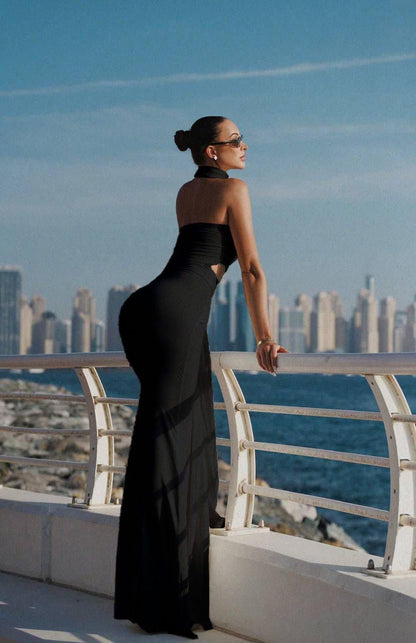 Minimalist black women’s dress with clean lines and an elegant silhouette that styles easily with heels or sandals.