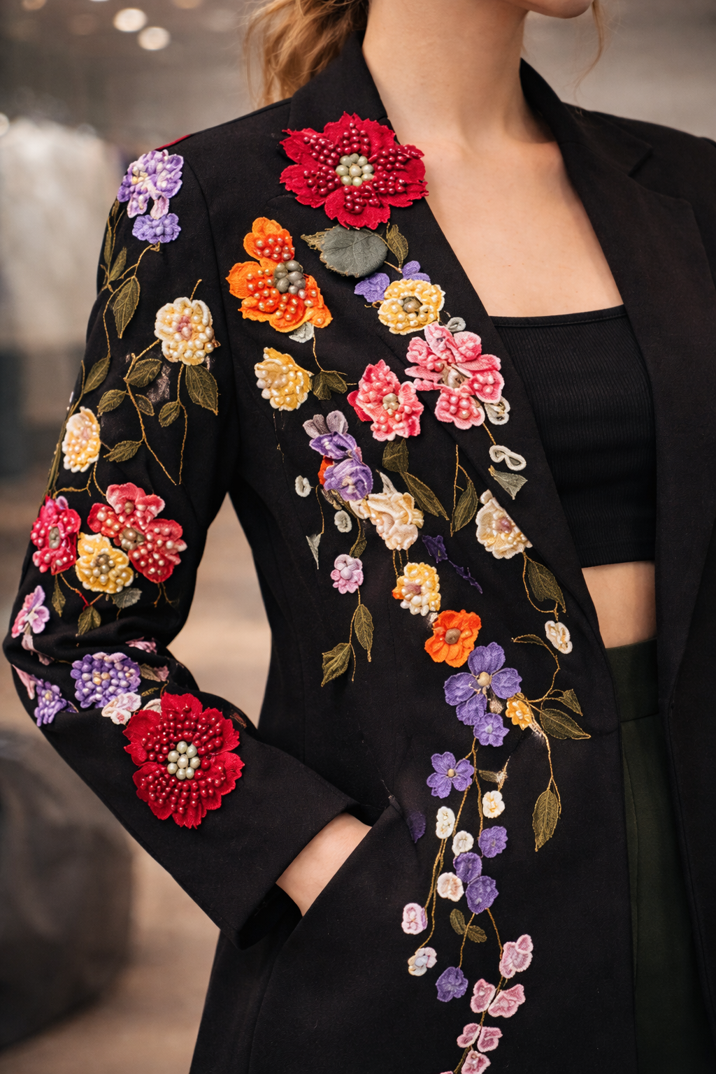 Black blazer with intricate multicolor floral embroidery along the lapel and sleeve